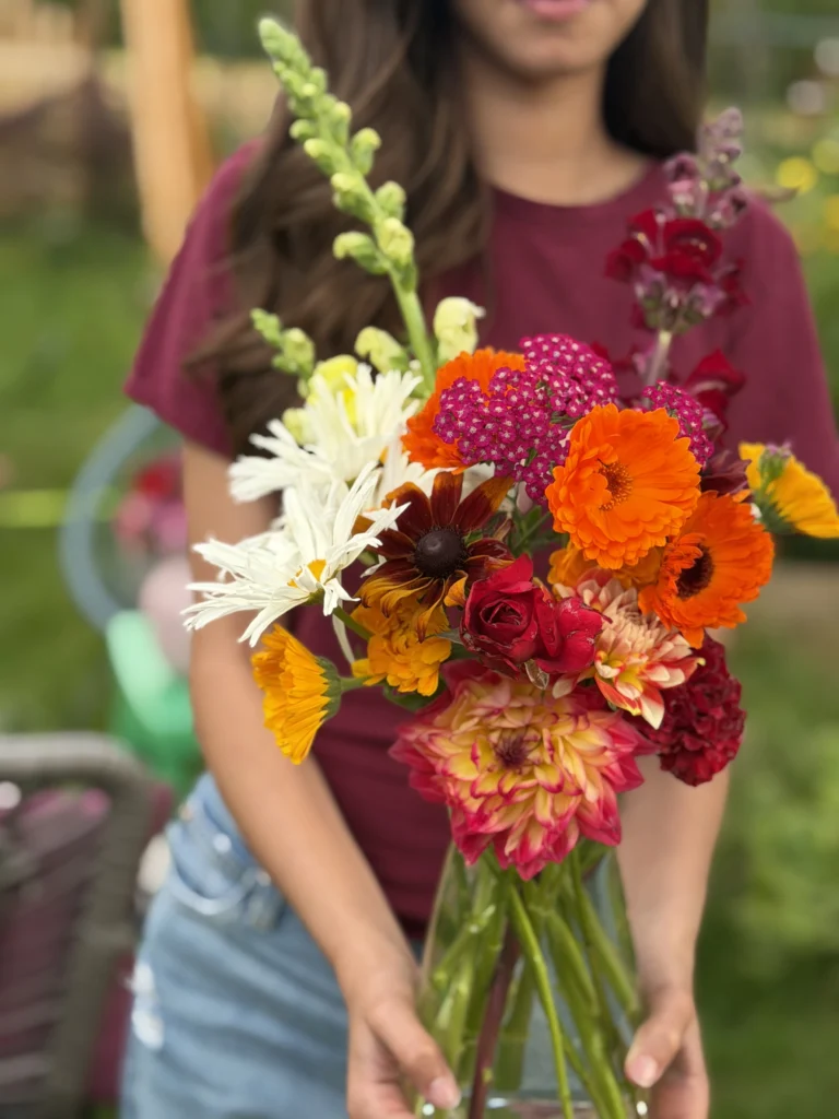 Garden Gather seasonal bouquet held for scale, published by Nero’s Langley Flower Shop